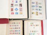 three open books with stamps on them sitting on a table