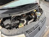 a dirty car with its hood open on the side of the road