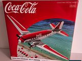 a coca cola airplane on display in a box