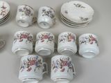 a lot of cups and saucers that are sitting on a table