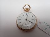 a gold pocket watch with roman numerals on it