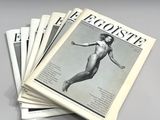 newspapers stacked on top of each other on a gray surface