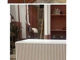 four pictures of a room with a radiator and a chair