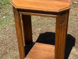 a small wooden table with a shelf on top of it