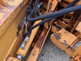a picture of a close up of a yellow bulldozer