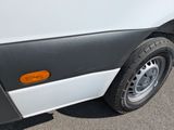 a close up of a white van parked in a parking lot