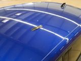 a close up of a blue car with a sticker on it