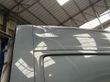 a white van parked inside of a building under a roof