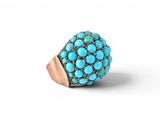 a close up of a turquoise stone ring on a white background