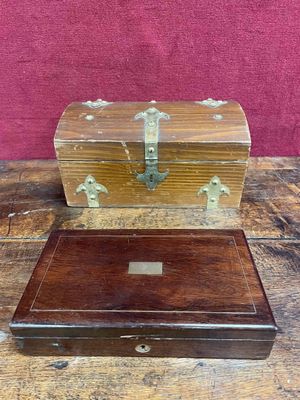 two wooden boxes sitting on top of a wooden table next to a red wall