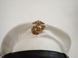 a white hat with a gold marine emblem on it