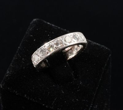a close up of a diamond ring on a black velvet surface