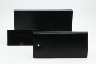 two black leather wallets sitting next to each other on a white surface