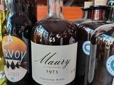 many bottles of liquor sitting on a wooden table