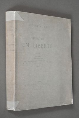 an old book sitting on top of a table next to a wall