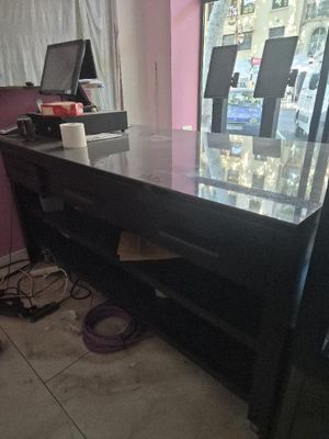 a desk with a computer on it in a room