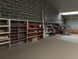a room with shelves, shelves, and boxes in it