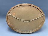 a brown plate with a wire wrapped around it