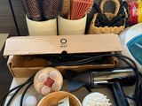 a table with a bunch of hair dryers and other items on it