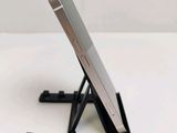 a cell phone that is on a stand on the table