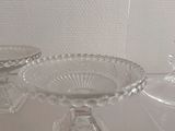 three clear glass dishes on a table with a white background