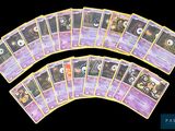 several pokemon cards are arranged on a black surface