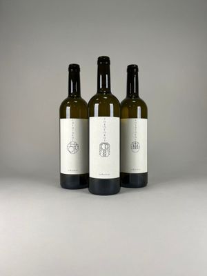 three bottles of wine sitting on top of a table next to each other