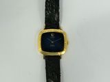 a close up of a watch on a white surface with a black strap