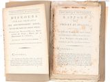 an old book opened on a white surface