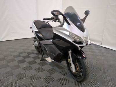 a picture of a motorcycle that is parked on a checkered floor