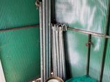 a pile of metal pipes in the corner of a room
