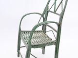 a green chair that is sitting on a white surface