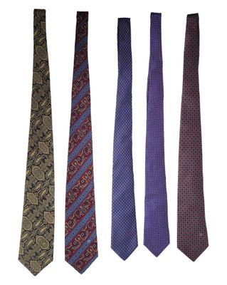 four different colored ties are lined up on a white surface