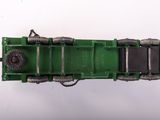a green toy truck that is sitting on a white surface