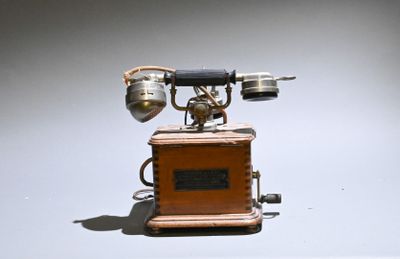 an old fashioned telephone that is sitting on a table