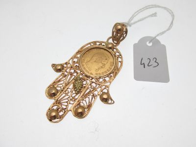 a close up of a gold coin on a string with a price tag