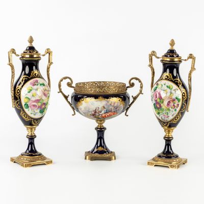 three vases with floral designs on them sitting next to each other