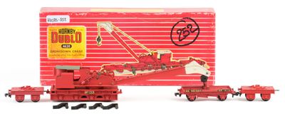 a red toy train with a crane on the tracks