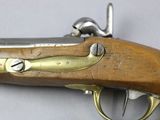 an old gun with a wooden handle on a white surface