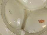 a white plate with a red design on it
