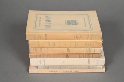 several books stacked on top of each other on a table