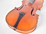 a violin that is sitting on a white surface