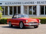 a red convertible car parked in front of a building