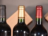 several bottles of wine are lined up on a shelf