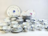 a lot of plates and cups sitting on a table