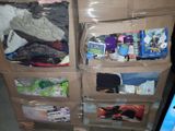 a carton filled with clothes and other items on the floor