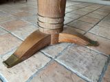 a close up of a wooden table on a tiled floor