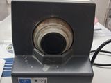 a small camera sitting on a table with a cord