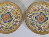three plates with asian writing on them are sitting on a table