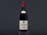 a bottle of wine sitting on top of a black table
